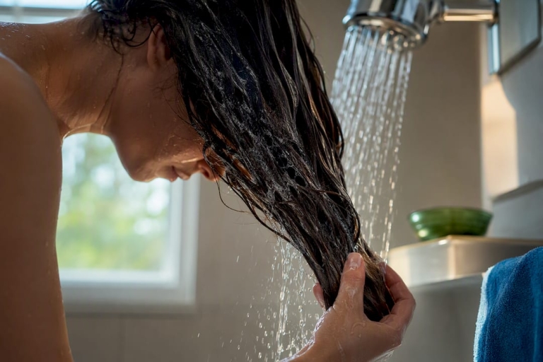 1790239199606_Hair-strands-rinsed-beneath-hard-water