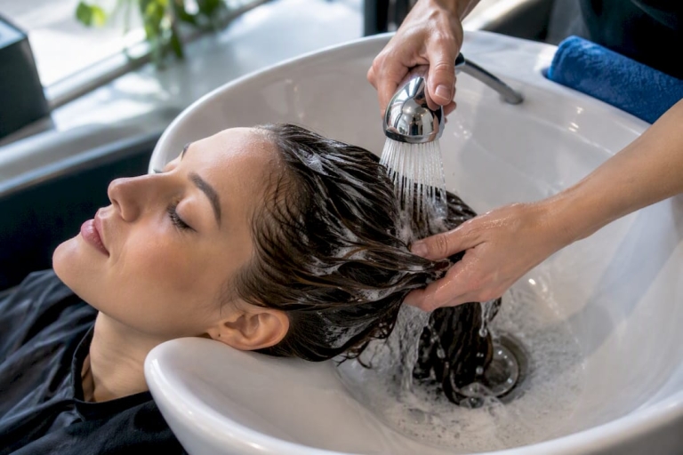 1790057049741_Hands-rinsing-hair-at-salon-basin